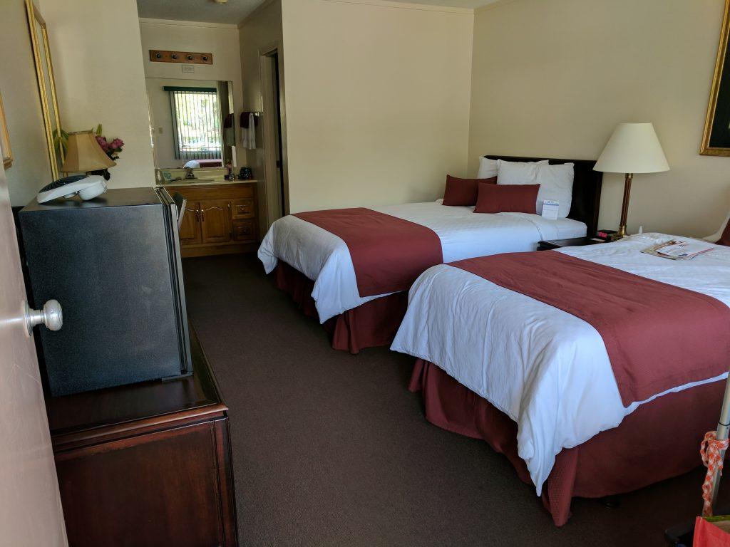 motel room at Lake Yale showing two double beds.  In the back of the room, the sink and mirror are visible.