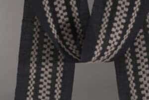 detail of handwoven scarf with three monks belt stripes is an example of supplemental warp