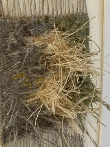 close up showing handwoven piece with wild grass is an example of texture in tapestry