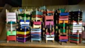 A pile of small frames, each wound with silk thread, on a table at Braids Conference in Japan