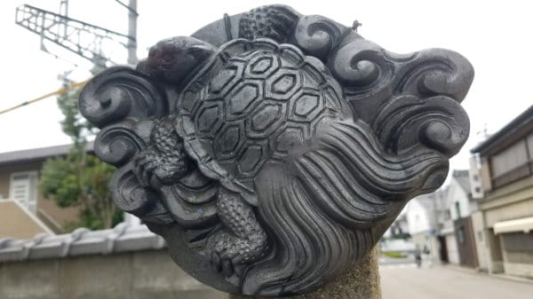 A sculpture in Japan depicting a turtle surrounded by waves